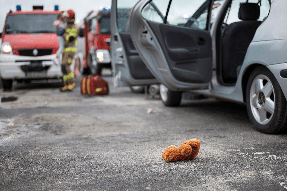 stuffed animal on the ground after a car accident