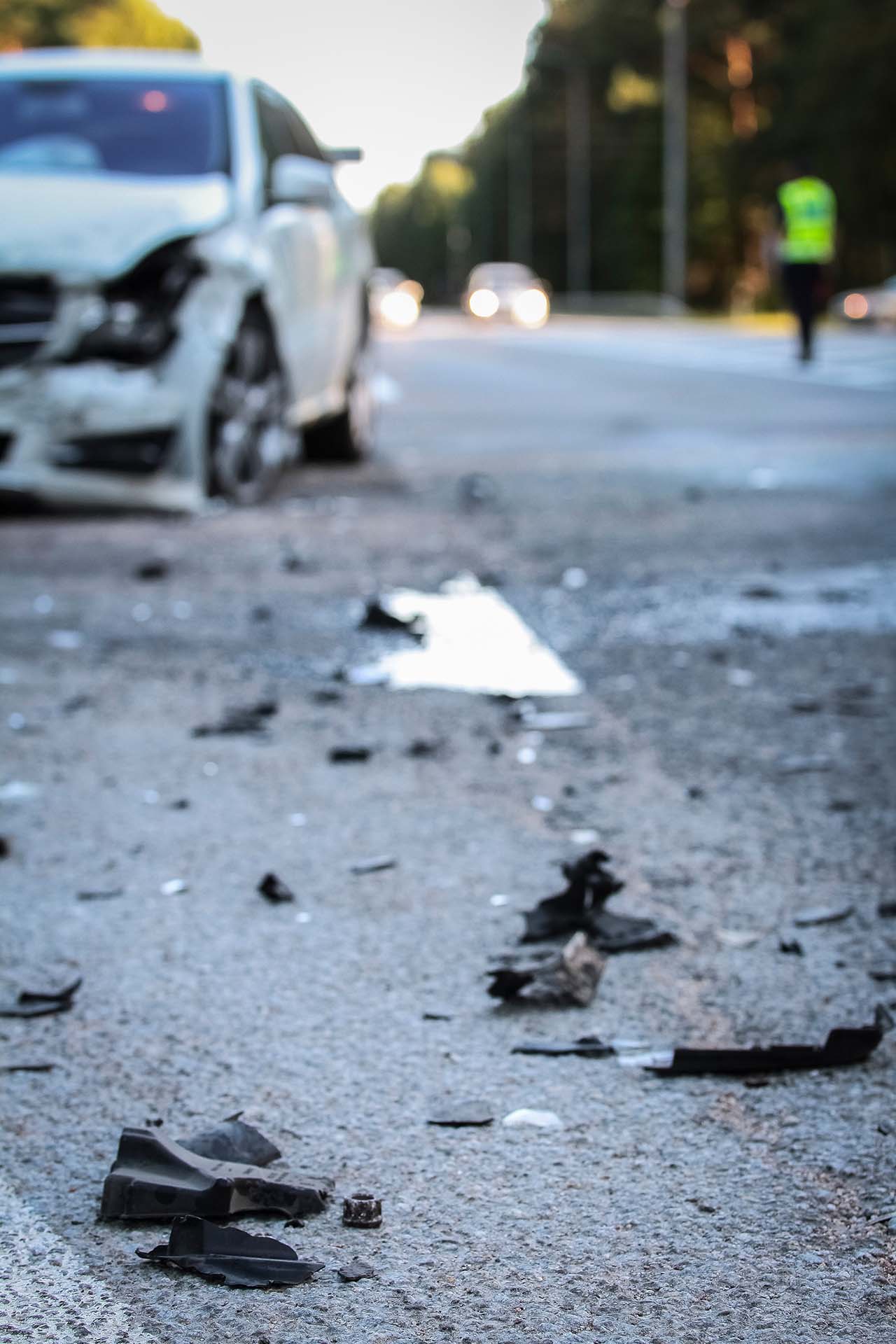 DUI Accidents - Two cars showing severe damage after a collision on a wet road